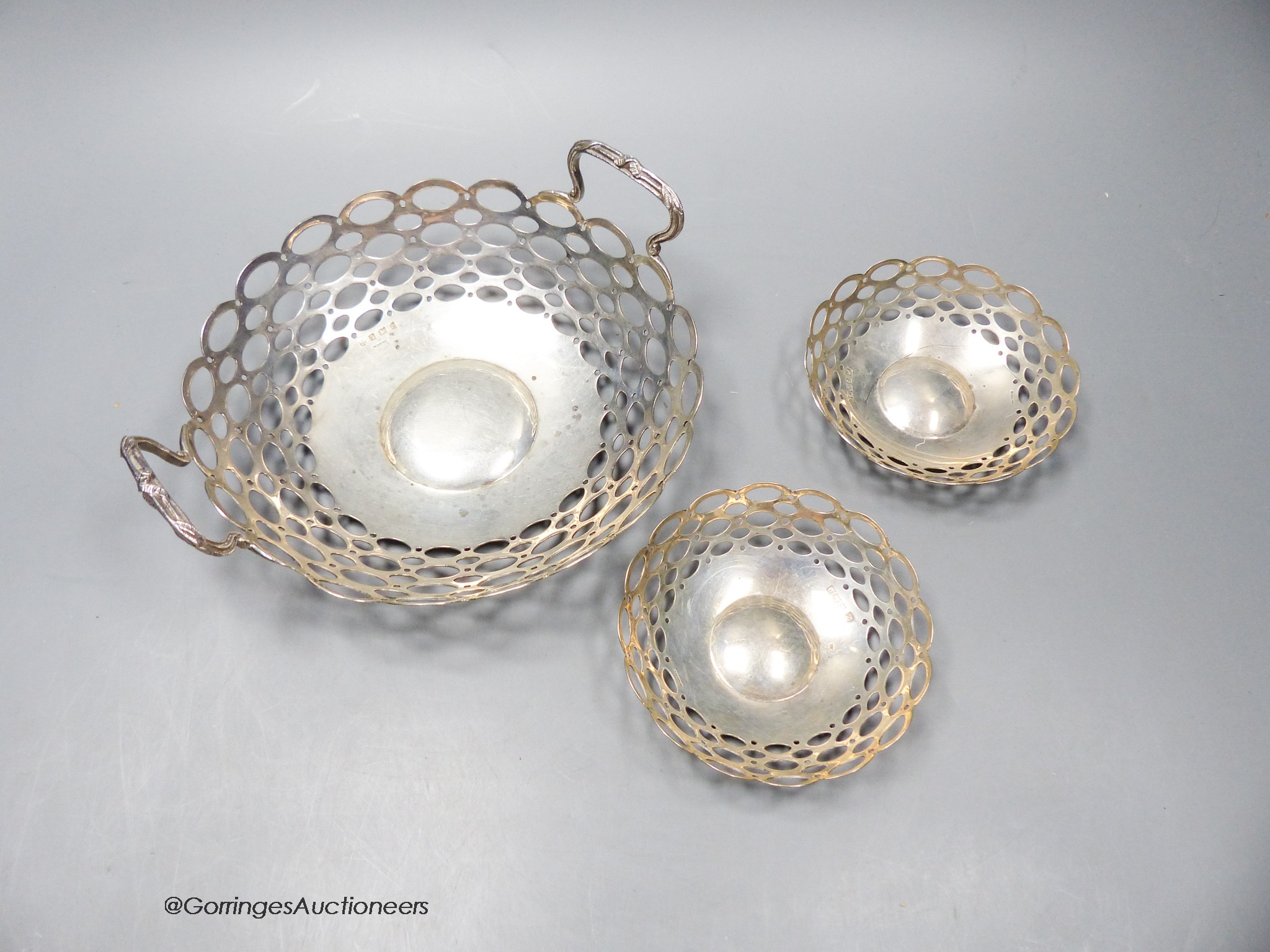 A graduated suite of Edwardian pieced silver bonbon dishes, 19.7cm(1) and 10cm(2), A&J Zimmerman, Birmingham, 1909 & 1914, 8.5oz.